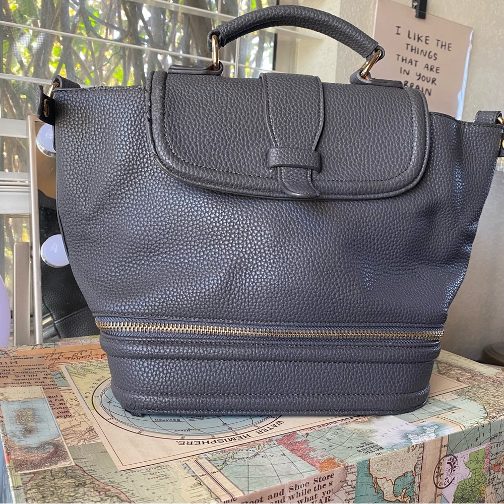 Slightly worn, spacious blue toned grey purse. Gold colored hardware.